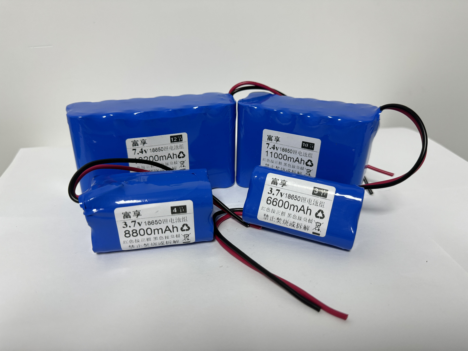 Pair of custom lithium battery packs in PVC shrink wrap with capacity labels